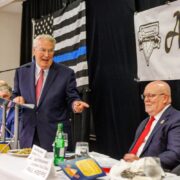 KDKA TV-2's Jon Delano gestures to Luncheon Vice Chair Paul Krepps & Committee Chair Dunn at Amen Corner Law Enforcement Awards Luncheon